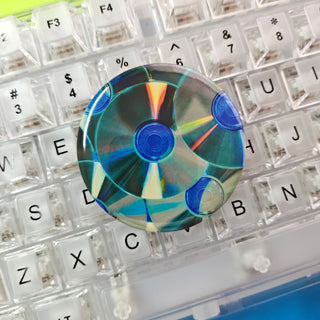 Multicolored CD on a transparent keyboard