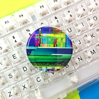 Colorful pixelated round object on a keyboard