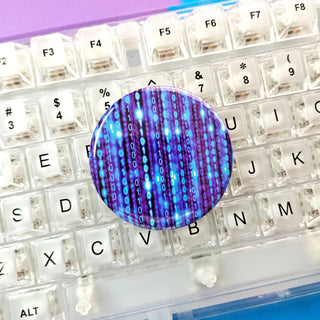 Close-up of a keyboard with a blue and purple circular object on top