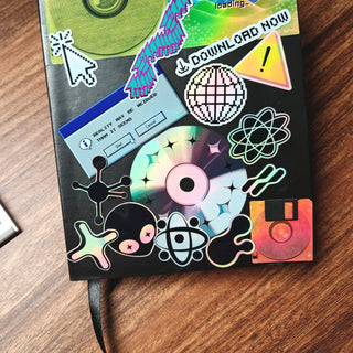 Notebook with colorful stickers on a wooden surface