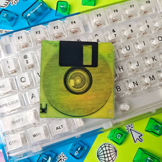 Colorful keyboard with a neon yellow floppy disk on top
