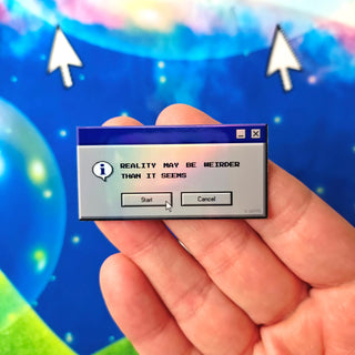 Hand holding a small computer window with text against a colorful, abstract background