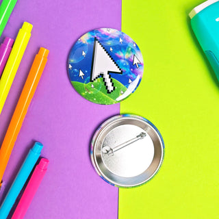 Pixelated button with a cursor design on a colorful background with markers.