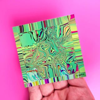 Colorful abstract design on a small card held against a pink background