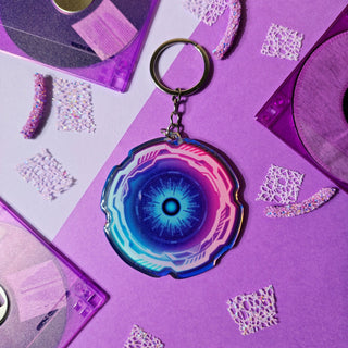 Keychain with a blue and pink design on a purple background