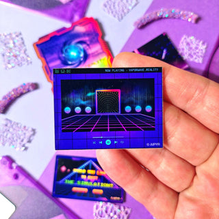 Hand holding a small square display with retro game graphics on a purple and pink gradient background.