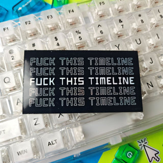 Keyboard with customizable keycaps and a black sticker with text on a colorful background