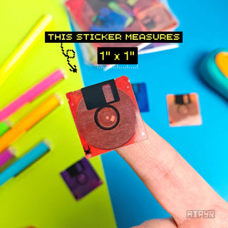 Hand holding a floppy disc-shaped sticker with measurement text on a colorful background