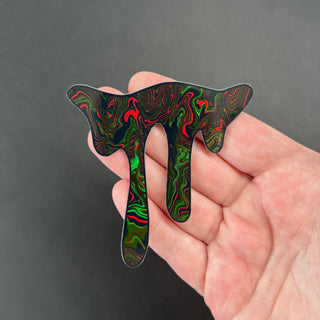 Infrared Swirl Holographic Drip Sticker by AIPYR laying on a human hand over a black background.