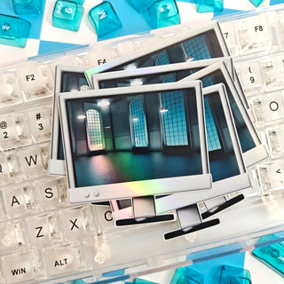 Stack of photo prints on a keyboard with blue and white elements