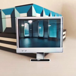 Computer monitor displaying a room with blue walls and windows, with a geometric sculpture in the background.
