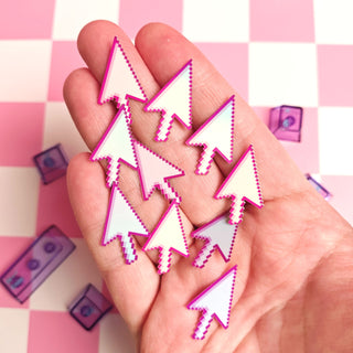 Hand holding pink and white arrow-shaped objects on a pink and white checkered background