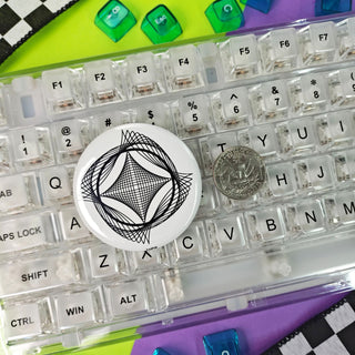 Close-up of a transparent keyboard with decorative keycaps on a colorful background