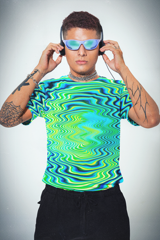 Person wearing a vibrant, patterned shirt with headphones on a plain background