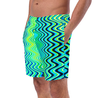 Side view of a man wearing the Neon Hypnosis Swim Trunks by AIPYR.