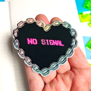 Heart-shaped 'NO SIGNAL' sticker held in a hand with colorful background