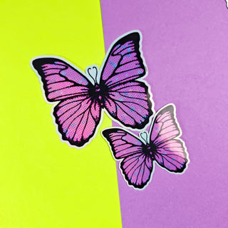 Two pink butterflies on a purple and green background