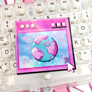 Pixel art of a heart and cloud on a computer screen with a keyboard in the background