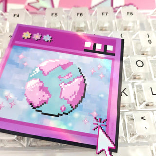 Pixel art design of a pink character on a computer keyboard key
