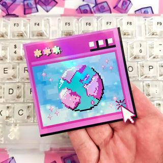 Hand holding a pixel art card with a character design on a keyboard background