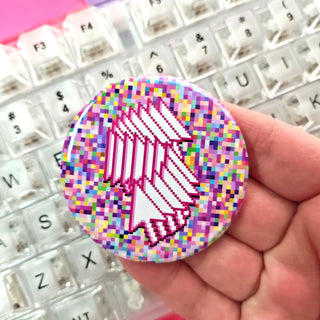 Pixelated circular object held over a keyboard