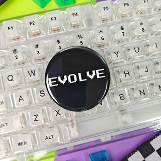 Keyboard with a 'Evolve' button and colorful keycaps on a checkered background