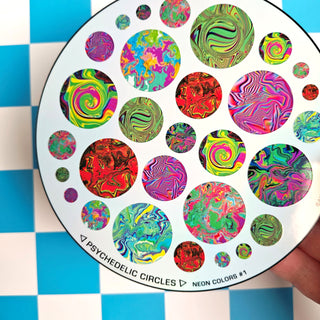 Colorful psychedelic circle design on a circular card held against a checkered background.