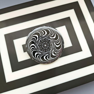 Black and white spiral design inside a rectangular frame