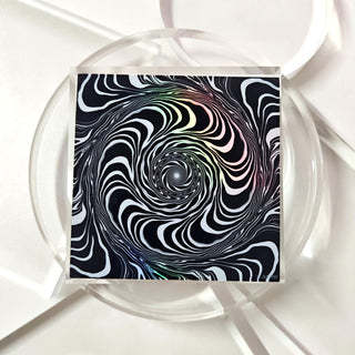 Abstract spiral design on a square tile with white circular frames in the background