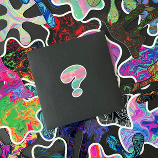 Trippy Blobs Holographic Sticker Pack by AIPYR in a black envelope with a question mark on it, laying on top of a pile of blob stickers.