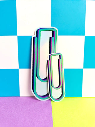 Colorful paper clips on a multicolored checkered background