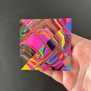 X Glitch Holographic Sticker by AIPYR laying on a human hand over a black background.