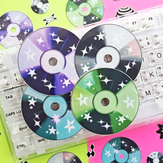 Colorful CDs with star patterns on a keyboard