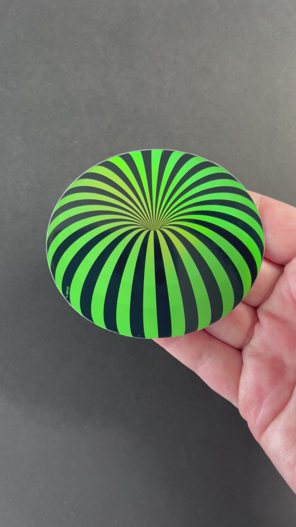 Video of the Neon Green Orb Holographic Sticker by AIPYR over a black background.