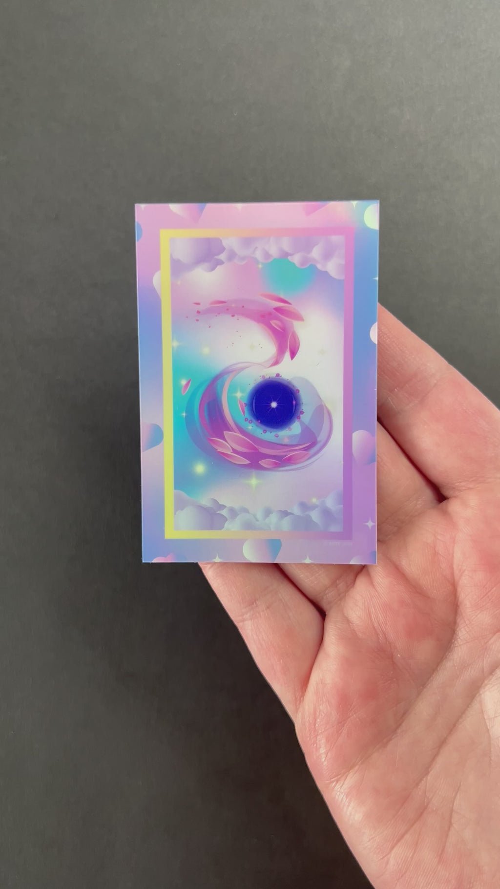 Video of the Ethereal Zephyr Holographic Sticker by AIPYR over a black background.