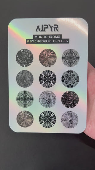 Video of the Monochrome Psychedelic Circles Holographic Sticker Sheet by AIPYR over a black background. 