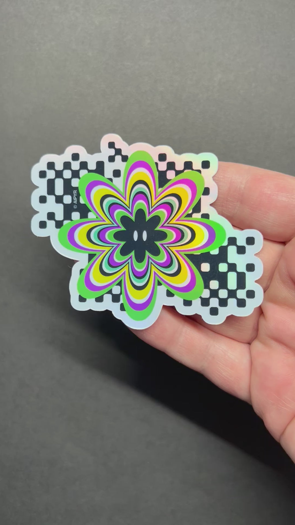 Video of the Y2K Digital Flower Holographic Sticker by AIPYR over a black background.